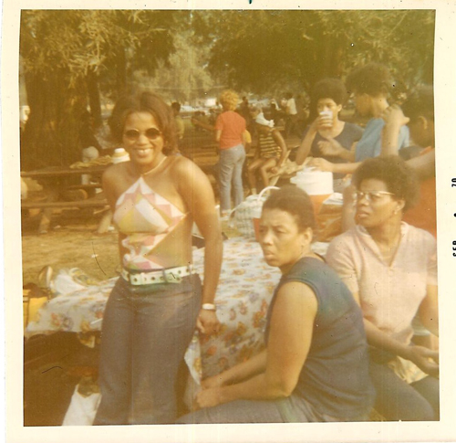 Rocking a Pucci cutout bathing suit and jeans for a cookout in 1976