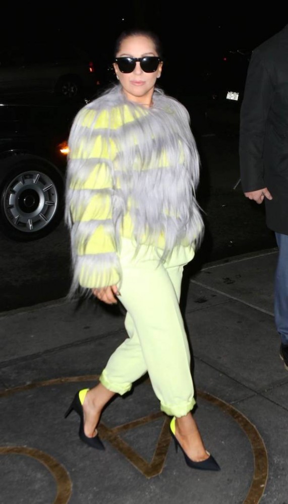 The fab Lady Gaga stepped in style while sporting a fur coat and pumps with neon accents. Hot!
