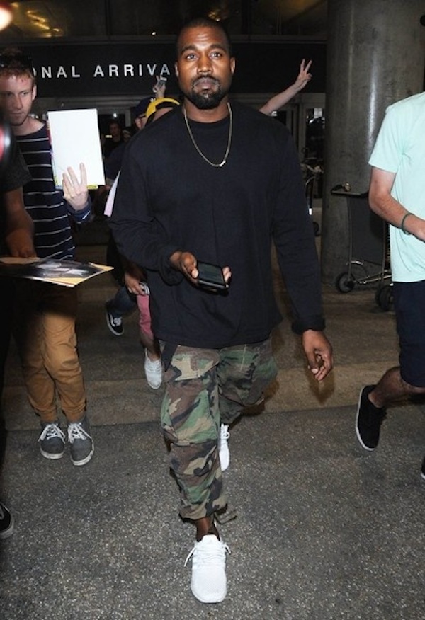 Kanye West was papped at LAX Airport in Los Angeles, dressed in camo cargo pants and a long sleeved black top..