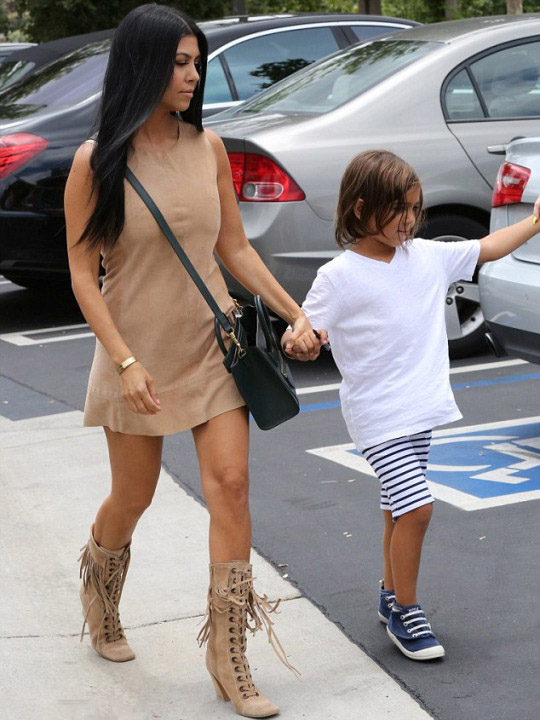 Kourtney Kardashian looked gorgeous with son Mason in a suede sleeveless shift and fringed lace up boots.