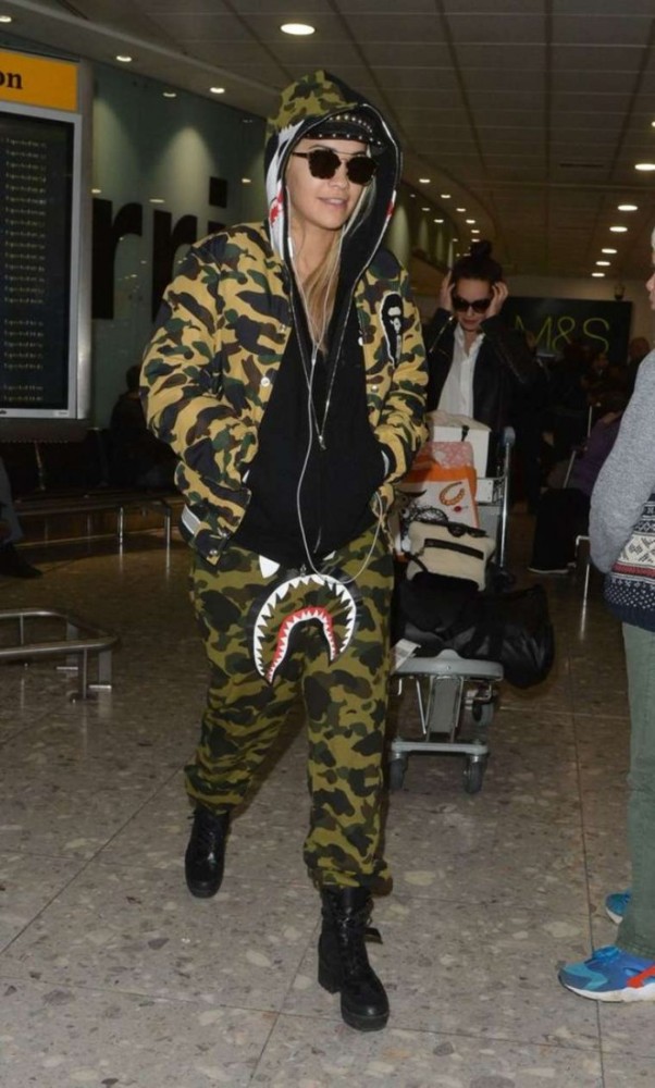 Splurge: Rita Ora's Heathrow Airport A Bathing Ape 1st Camo Varsity Light Down  Jacket, Shark Gore-Tex Windstopper Sweatpants, and Louis Vuitton Palm  Canyon Desert Boots