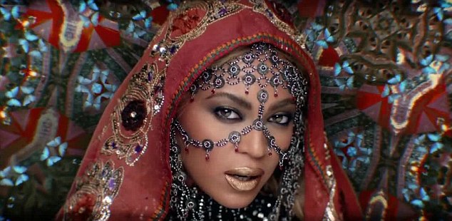 1 Beyonce Wears Abu Jani Sandeep Khosla Gold and Red Sequined Hand Embroidered Dress, a Laurel Dewitt Crown, and an Erickson Beamon Necklace in Coldplay's Hymn for the Weekend Video