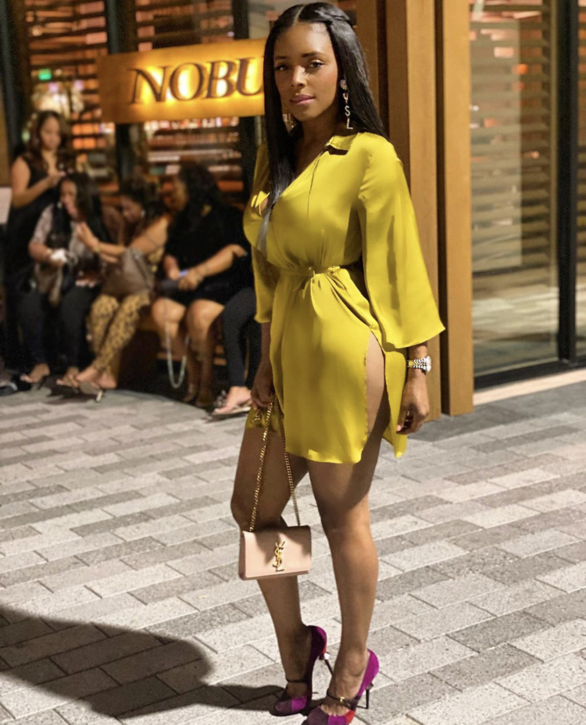 You Ask, We Answer! Angel Love Wore a $40 Mustard Zara Belted Satin Dress, Miu Miu Suede Color Block Pumps, and Beige Saint Laurent Chain Wallet at Nobu