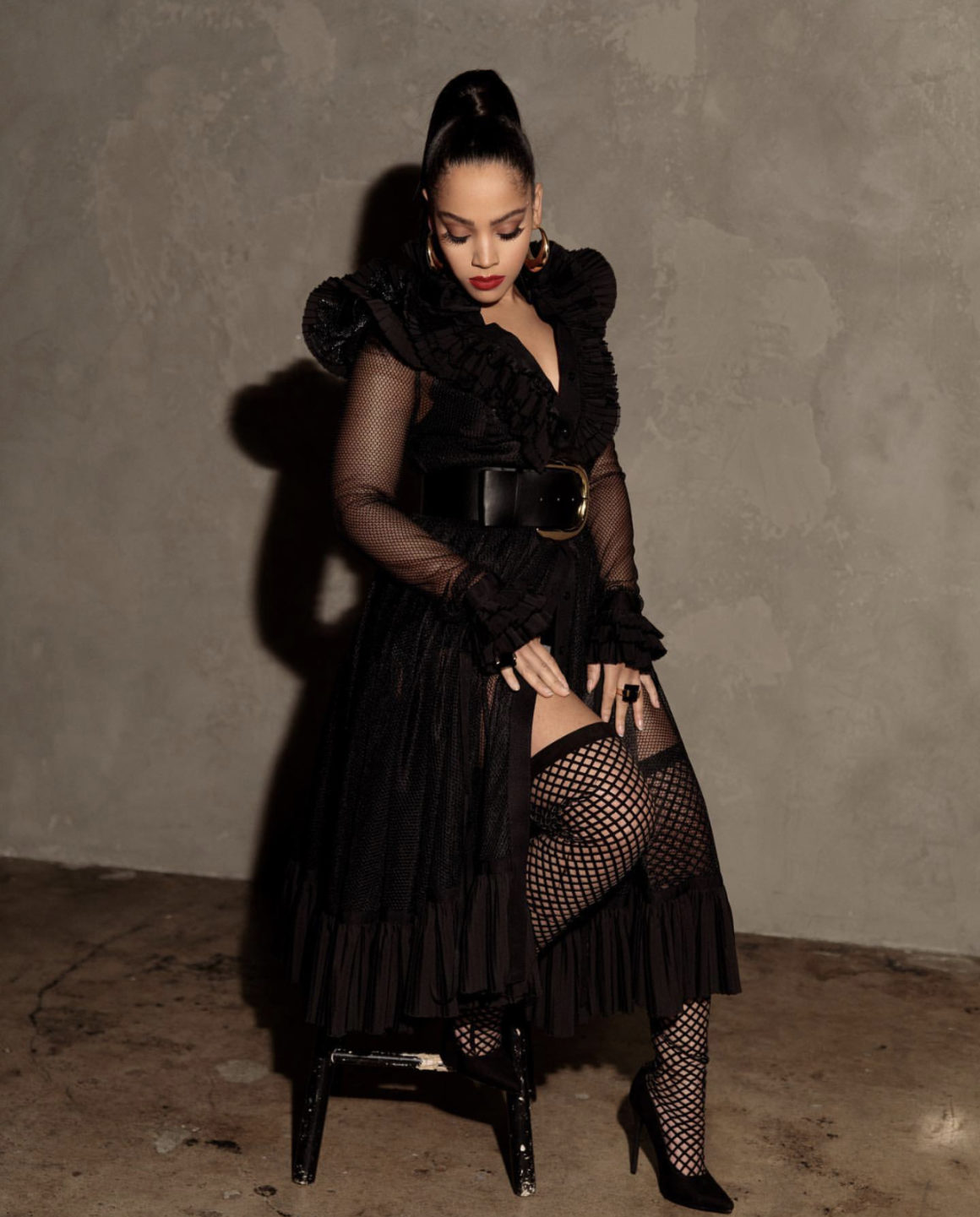 Bianca Lawson Posed for a Shoot Wearing UNTTLD Black Ruffled Fishnet Mesh Dress With Berna Peci Gold Hoops and Nasty Gal Accessories2