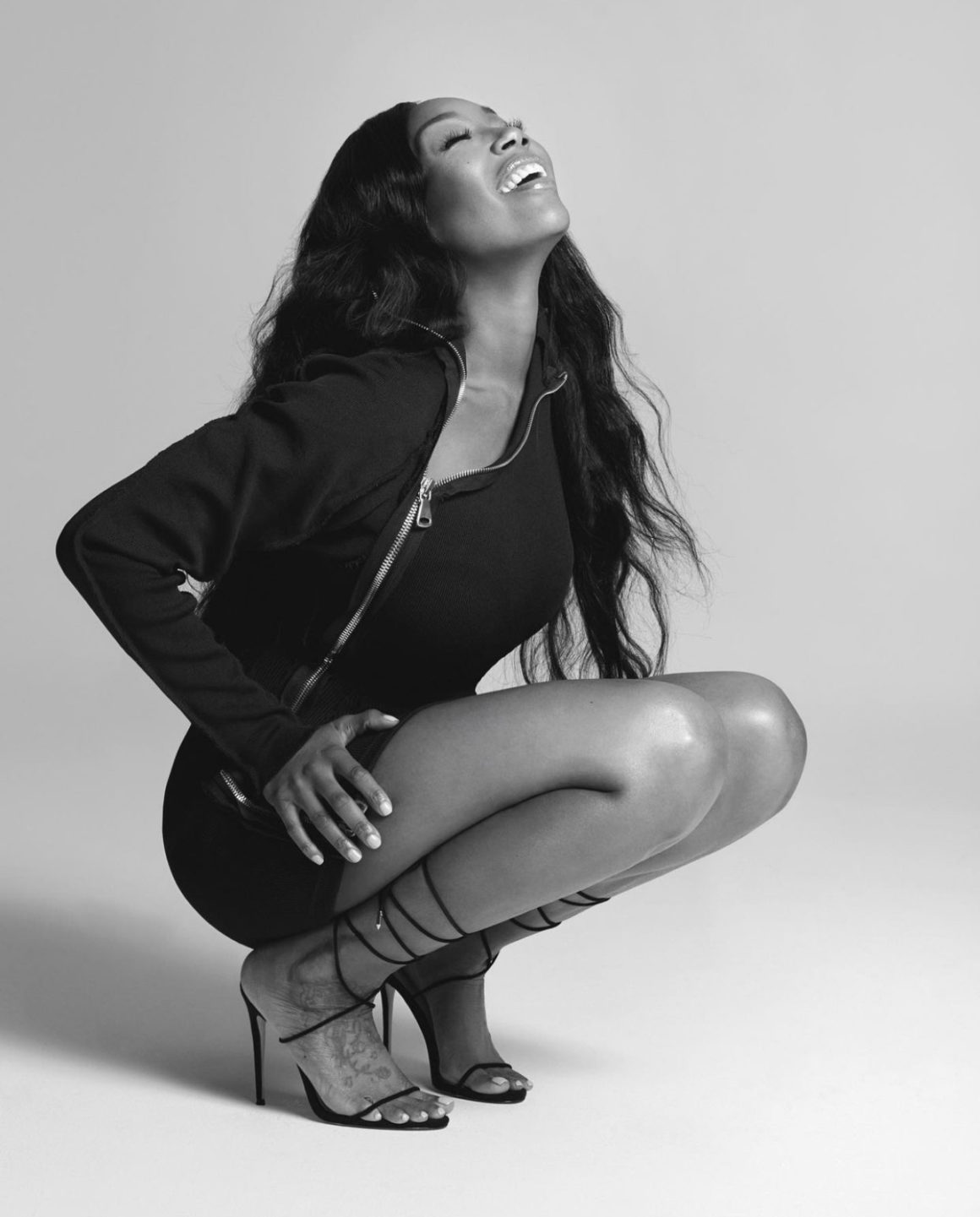 Brandy Stuns in Black and White Photoshoot Wearing Lionne Clothing Black Long Sleeve Zip Up Mini Dress and Femme LA Black Lace Up Sandals7