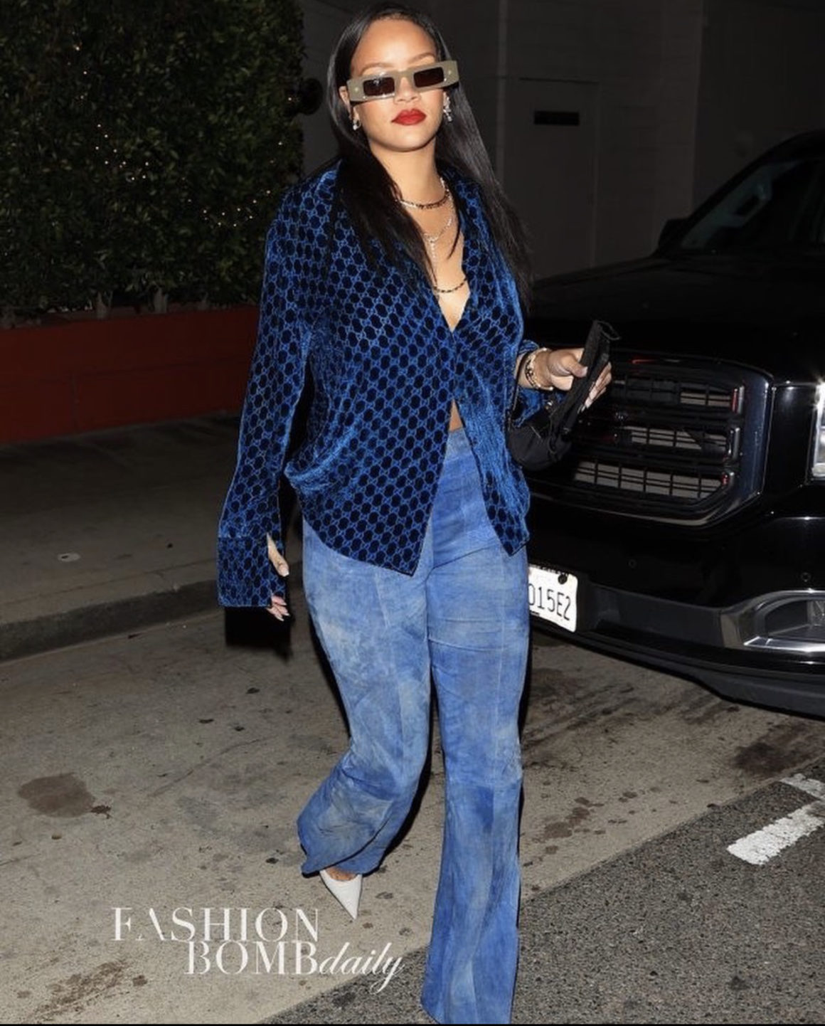 Rihanna Gives Us the Blues in a Good Way Wearing Vintage Gucci Velvet Monogram Shirt and SPRWMN Blue Suede Flared Pants Paired With Vintage Fendi Black Mini Bag and Amina Muaddi White Pumps