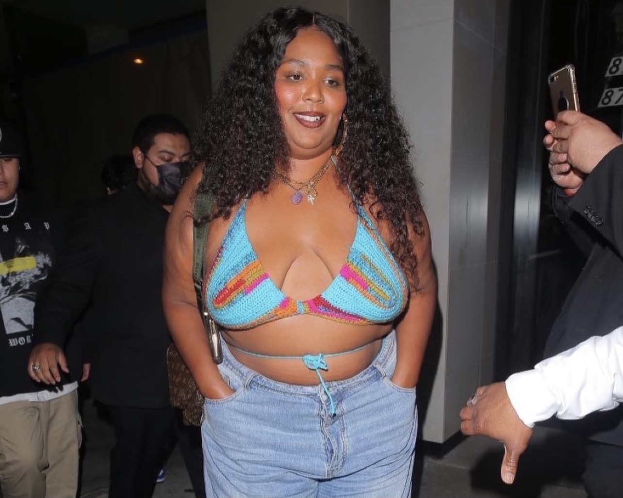 https://fashionbombdaily.com/wp-content/uploads/2021/05/Lizzo-Spotted-at-Catch-LA-Wearing-Knits-and-Pieces-Custom-Multicolor-Crochet-Bralette-Distressed-Jeans-and-Nike-Sneakers-.jpg