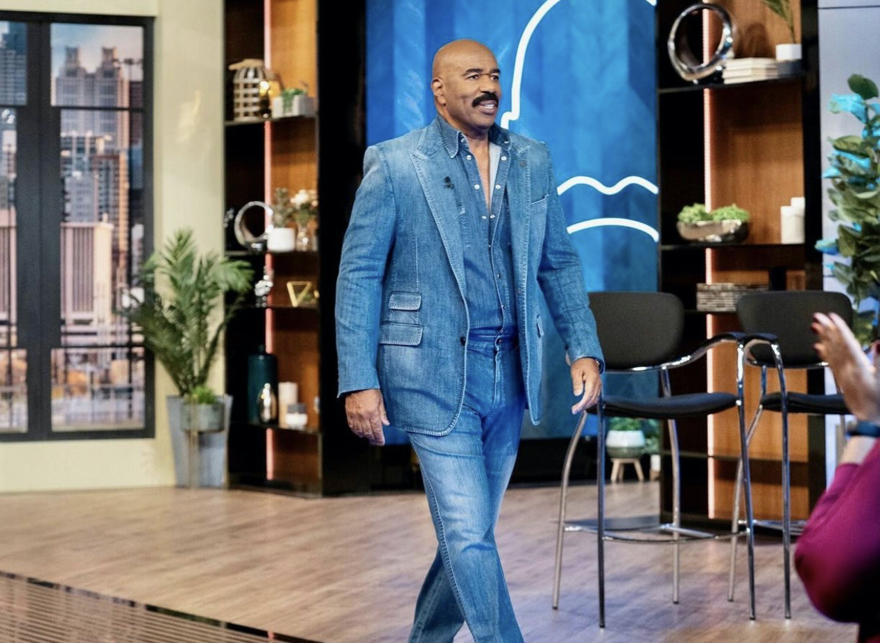 Steve Harvey Steps in Abu Dhabi Styled in a Louis Vuitton x Virgil Abloh  Purple and Green Landscape Jacket and Matching Shirt – Fashion Bomb Daily