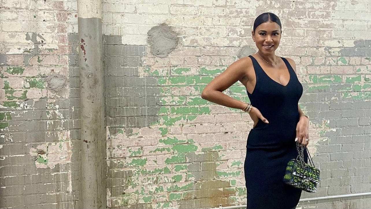Eniko Hart Strikes a Pose While Slaying in a ALEXIS Black V-Neck Dress,  Chanel Bag, and Off-White Black Bow Mules – Fashion Bomb Daily