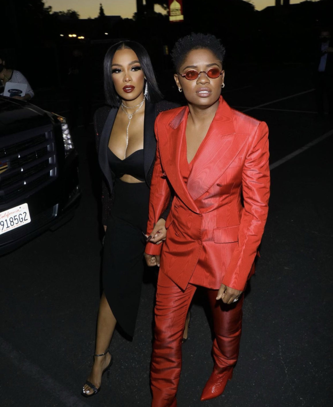 Bre Z and Chris Amore Supply Bomb Couple Style Moment at the The Harder They Fall Premiere in LA Bre Z Wears Dolce and Gabbana Red Suit and Chris Wears Saint Laurent Black Look4