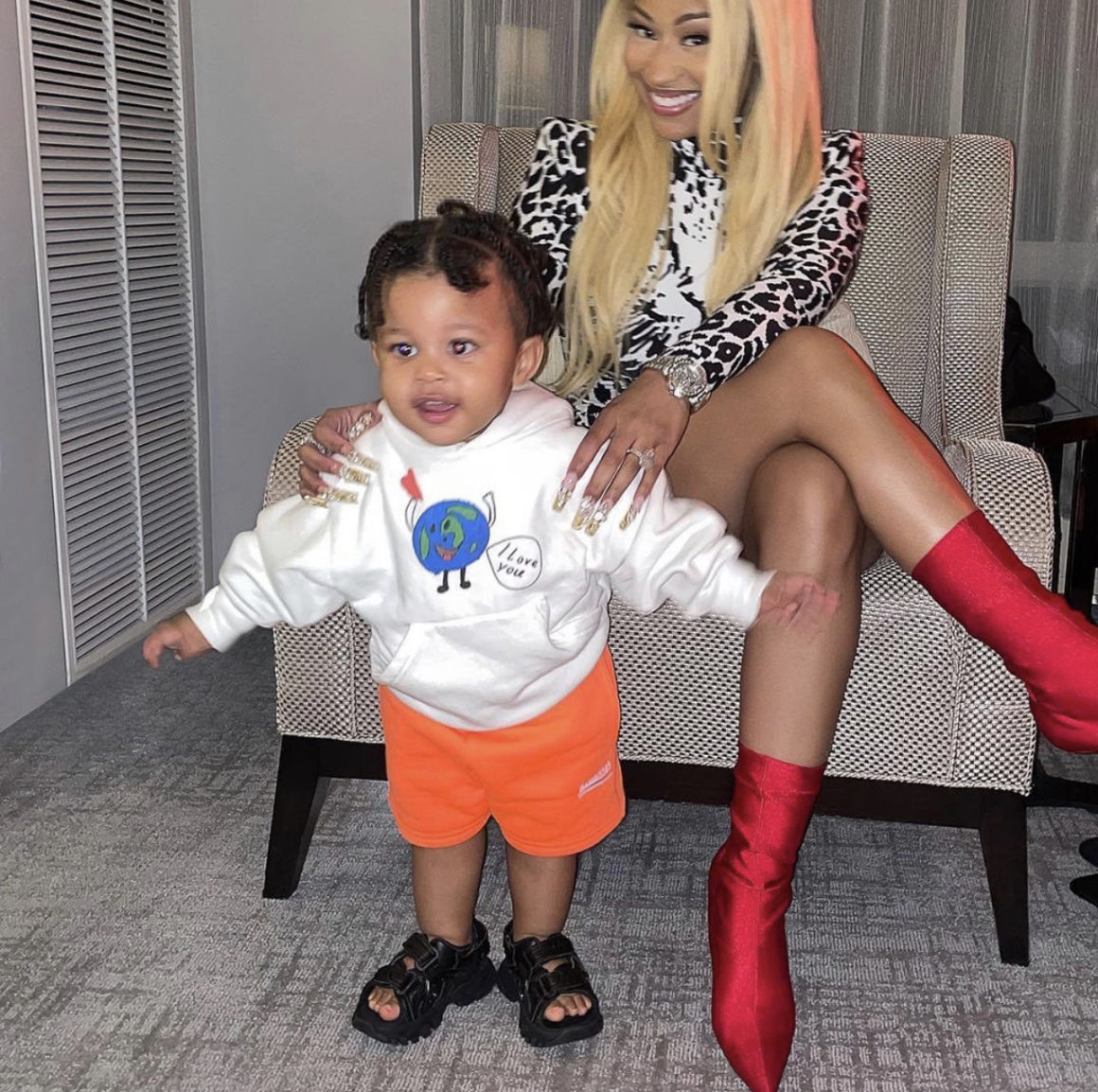 Nicki Minaj Shares Photos of Son Papa Bear Wearing Balenciaga White Earth Print Hoodie Orange Logo Shorts and Black Sandals