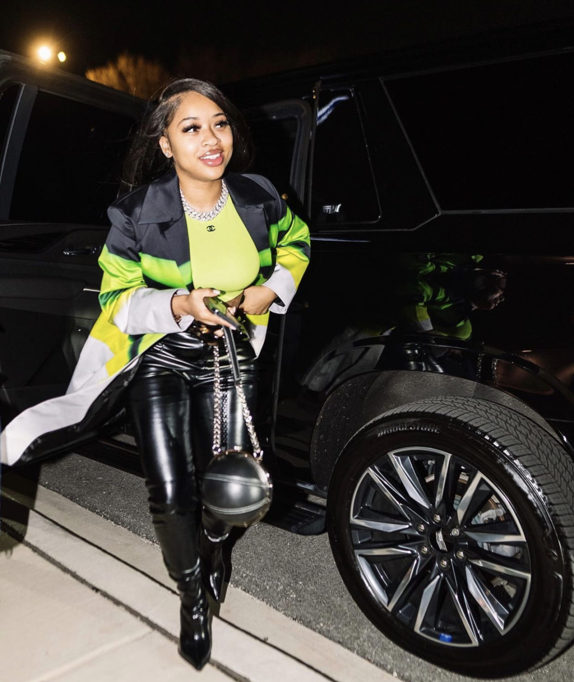India Royale Steps Out in Neon Green and Black Look Featuring Fashion Nova Black Leather Pants