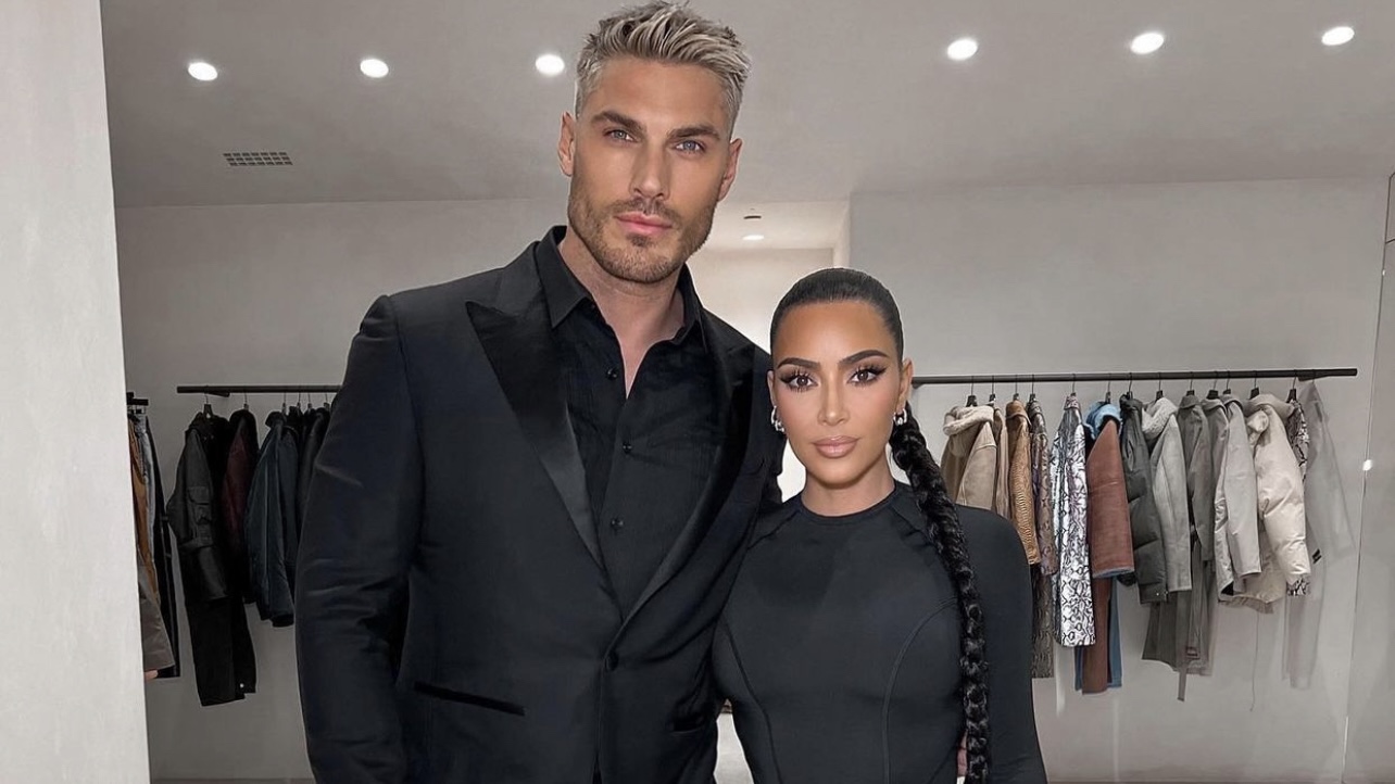 Kim Kardashian Poses With Hairstylist Chris Appleton Wearing Balenciaga Black Top and Leggings Look cover