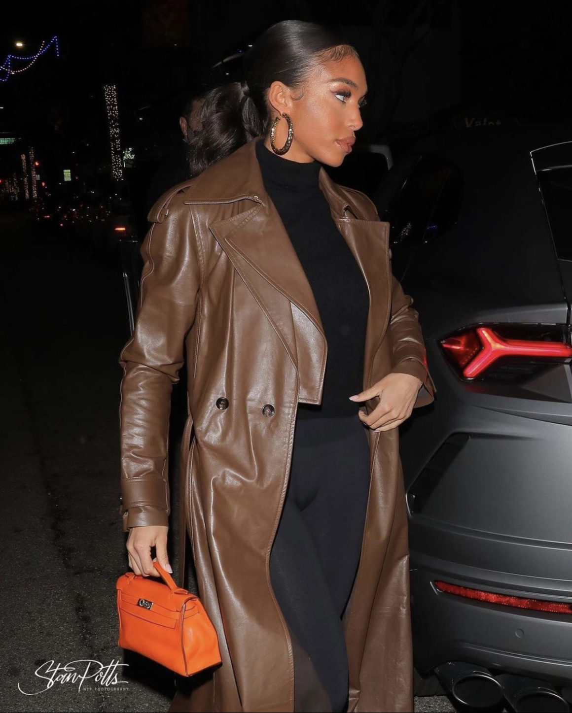 Lori Harvey Grabs Dinner in Beverly Hills Wearing Bottega Veneta Brown Leather Trench Coat Wolford Black Top and Leggings and Louis Vuitton Colorblock Knee High Wedge Boots2
