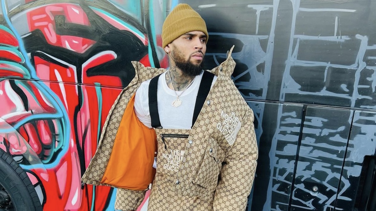 Chris Brown Spotted in Gucci x The North Face Monogram Jacket and Overalls Paired With Air Jordan Sneakers