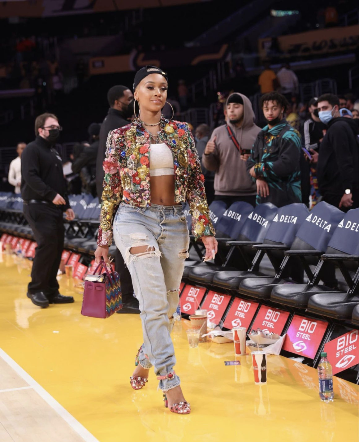 Wardrobe Inquiry: Saweetie Attends Lakers vs. Timberwolves Game in LA  Wearing Dolce and Gabbana Embellished Jacket and Pink Heels Paired with  White Crop Top, Distressed Jeans and Goodie Black Hat
