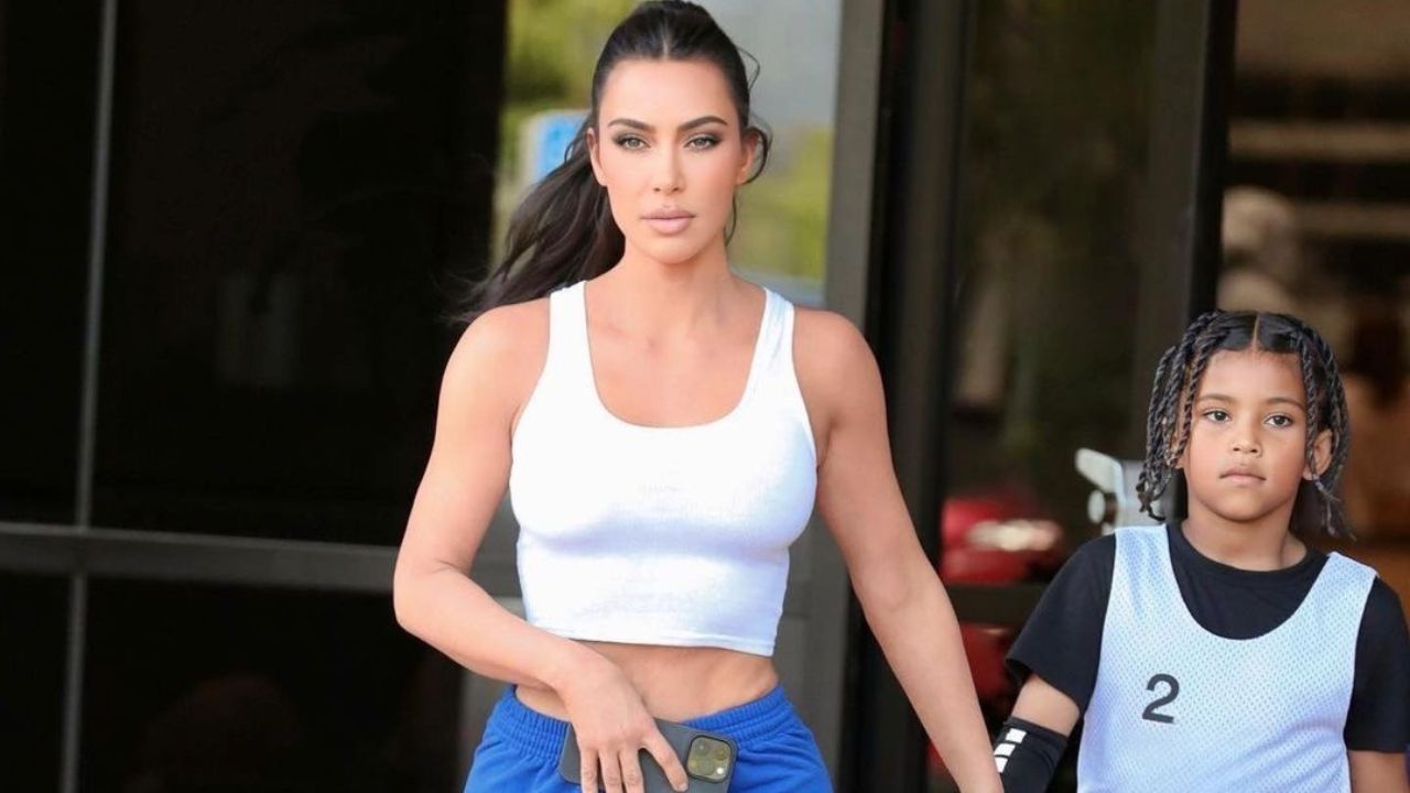 Kim Kardashian Wore a White Crop Top and Blue Sweatpants with Travis Scott Air Jordan 1’s to Saint West Basketball game in L.A.