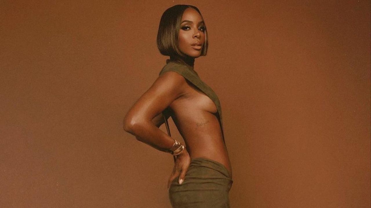 Kelly Rowland Stunned in a $1,000 Olive Green LaQuan Smith High-Cut Bodysuit with a Matching $1,300 Maxi Suede Skirt
