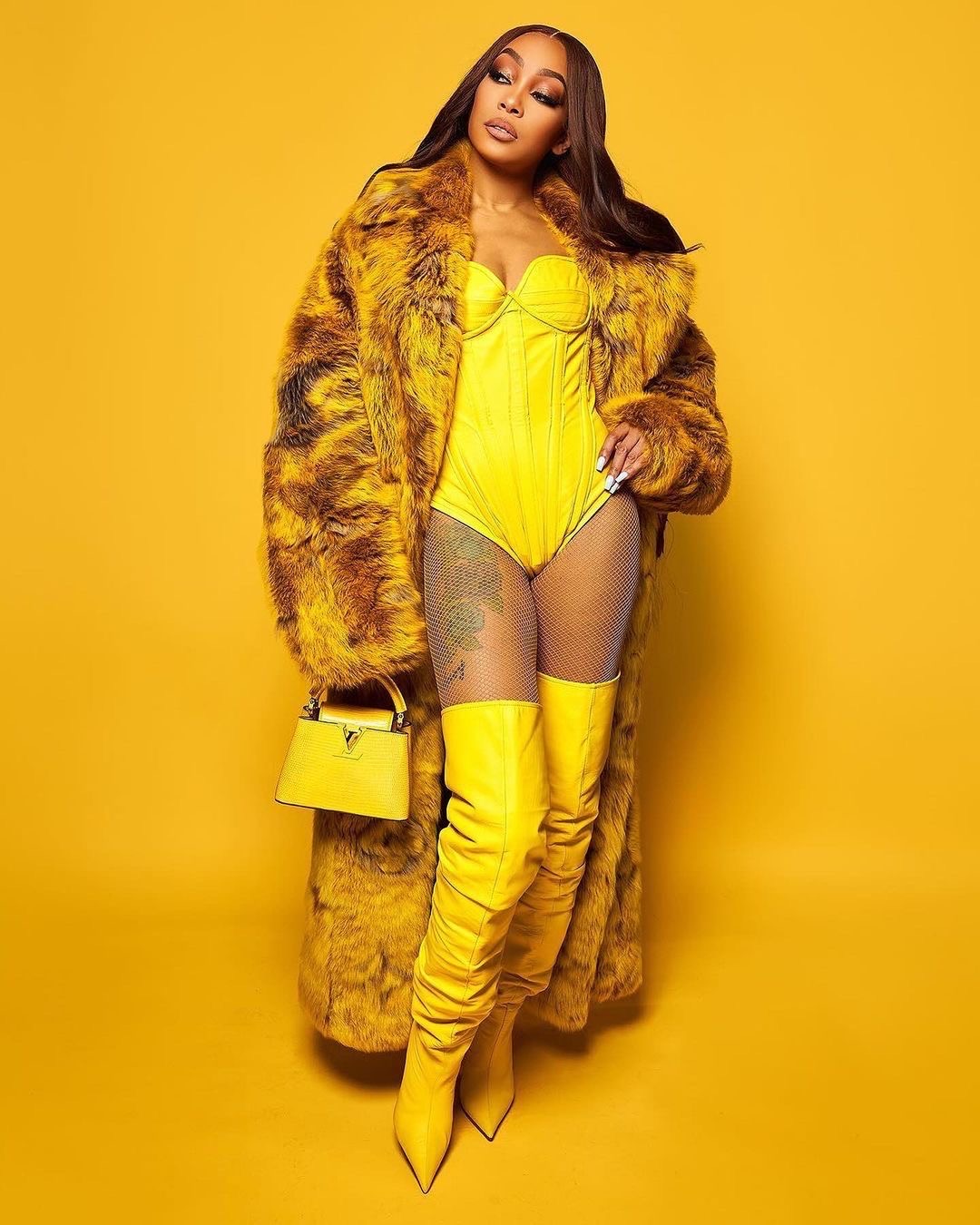 Monica Performed at Nicki Minajs Pink Friday 2 World Tour in a Yellow Louis Vuitton SS24 Fur Coat 1