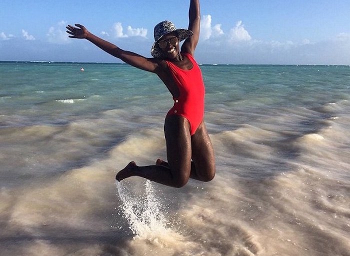 Splurge: Lupita Nyong’o’s Instagram Thapelo Paris Red Gold-Tone Button Detail Scoop Side Swimsuit