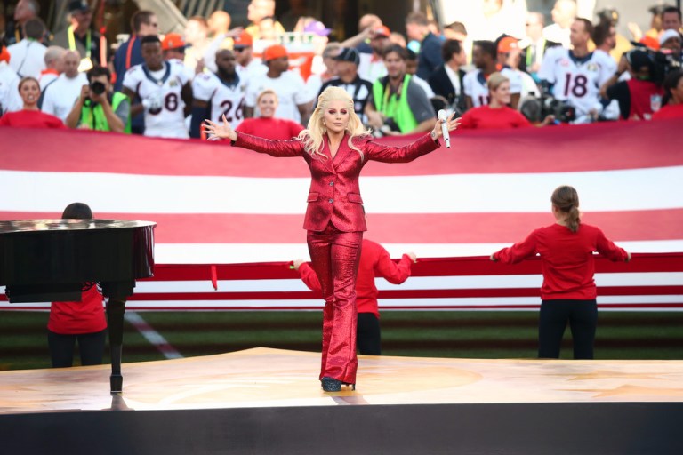 Lady Gaga Sings the National Anthem at Super Bowl 50 in a Gucci Red Pant Suit