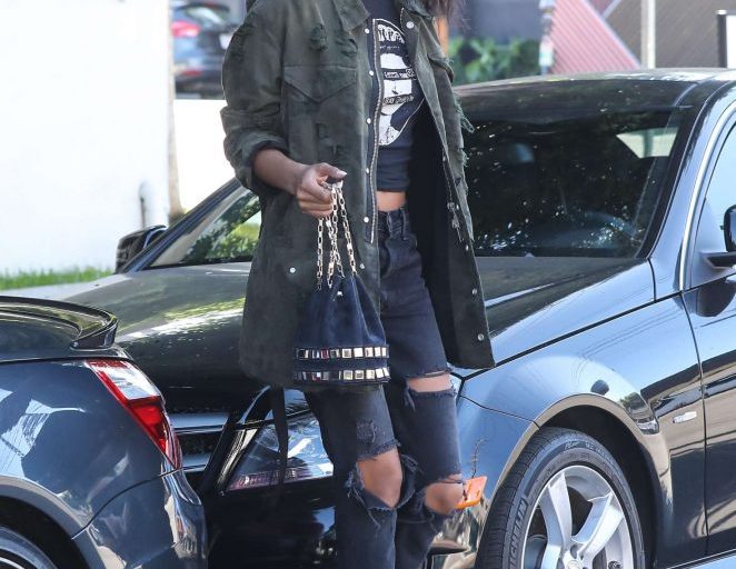 Splurge: Chanel Iman’s West Hollywood $1,460 Unravel Project Green Frayed Military Jacket, $2,115 Tomasini Studded Bucket Bag, and $320 Schutz Jolana Boots
