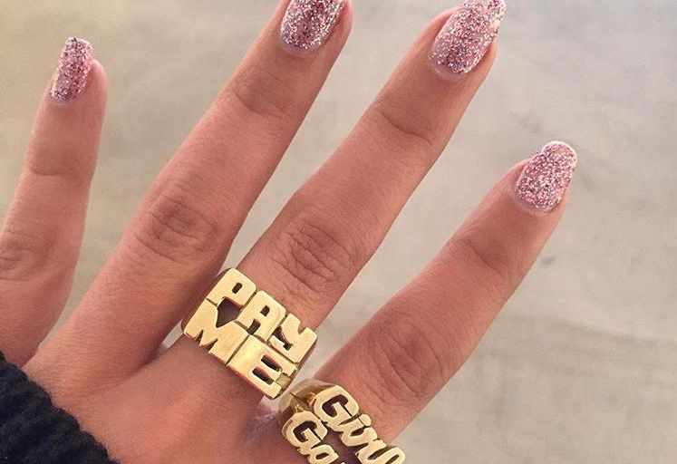 Bomb Product of the Day: Melody Ehsani’s “Pay Me” and “Girl Gang” Gold Dipped Script Rings