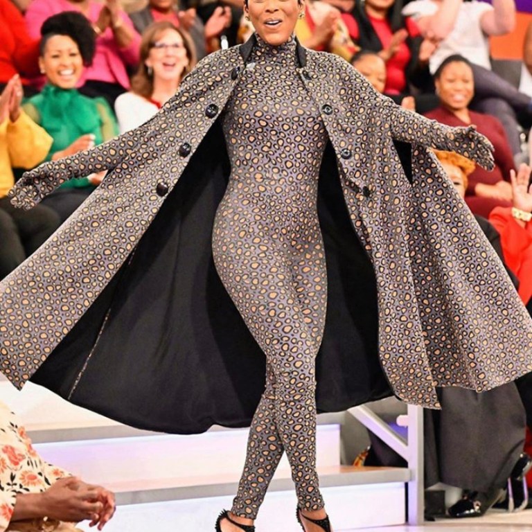 Tamron Hall Wears A David De la Cruz Grey and Yellow Animal Print Cat Suit With Matching Cape on the Tamron Hall Show