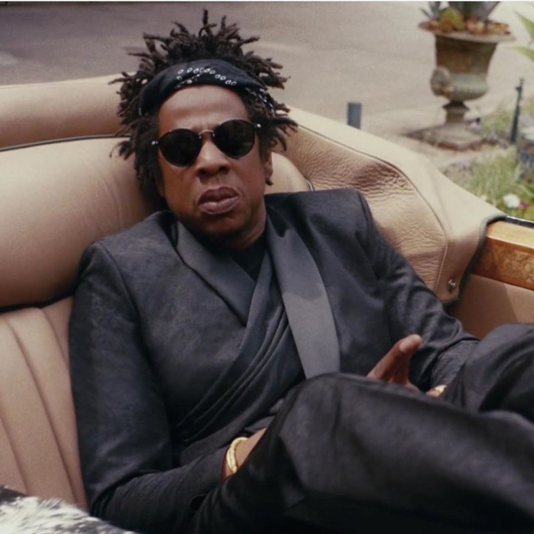 Jay Z ‘s Black is King Looks Were Fire: His Draped Black Dior Fall 2019 Suit, Red Givenchy Look, Sergio Tacchini Polo, Lisa Eisner Chain, and More, Styled by June Ambrose