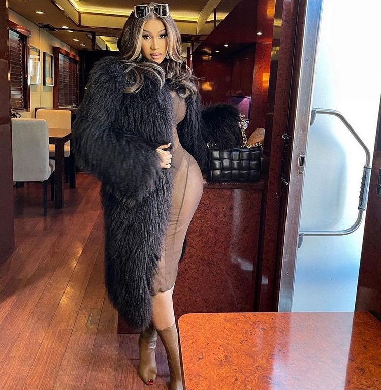 Cardi B Poses Wearing a Brown Dress by Mahjing Wong a Black Vintage Gucci Coat and Bottega Venta Bag
