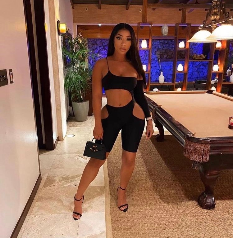 Tommie Accented Fashion Nova’s Black Romper with Tom Ford Pad Lock Heels