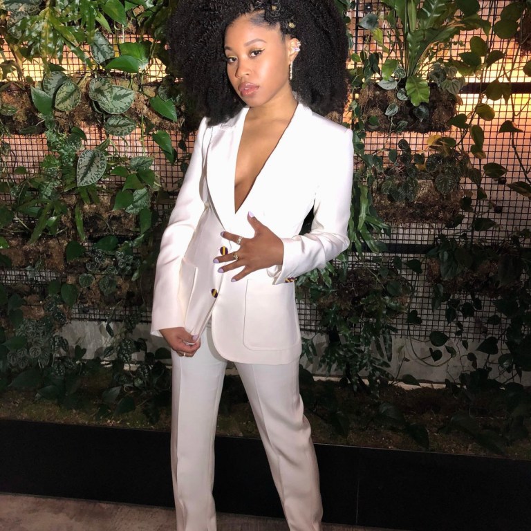 ‘Judas and the Black Messiah’ Star Dominique Fishback Appeared on Jimmy Kimmel Live in Louis Vuitton Pre-Fall 2020 White Button-Up Suit and Gold Giuseppe Zanotti Heels