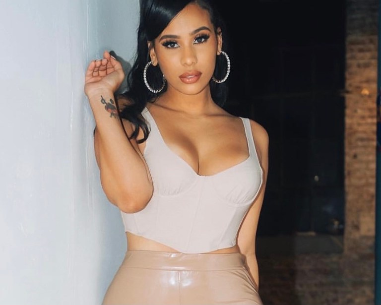 Cyn Santana Posed in Nude Latex Stacked Pants by Fashion Nova