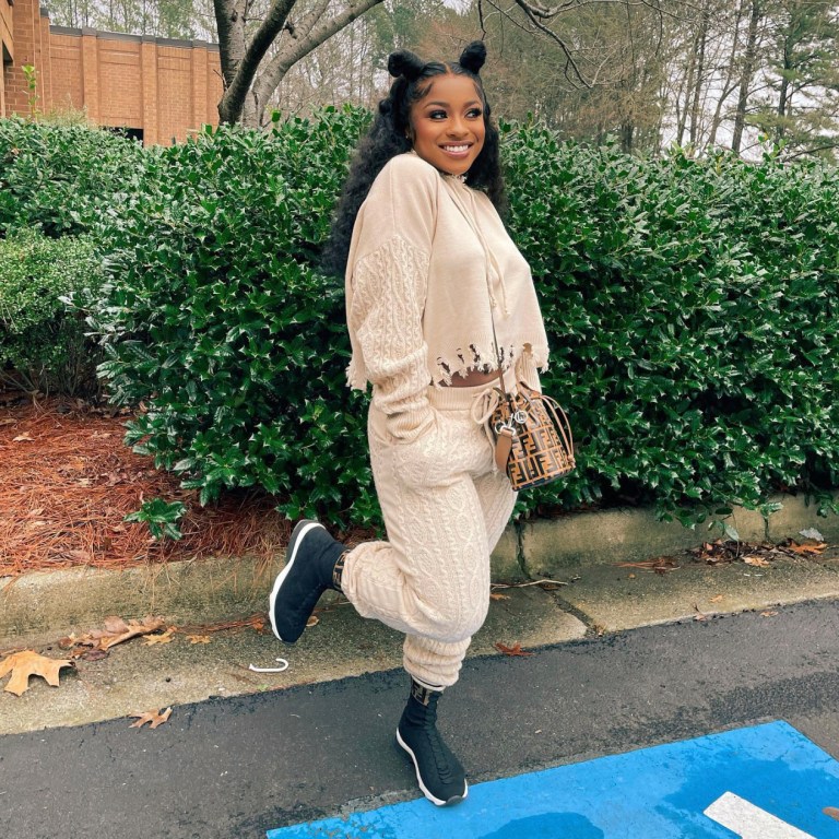 Reginae Carter Keeps It Cozy and Casual in Fashion Nova Cream Distressed Cable Knit Two Piece Set
