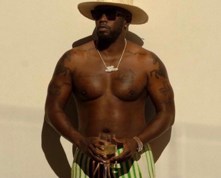 Wardrobe Inquiry: Diddy Spotted Vacationing in the Bahamas Wearing Issey Miyake White Button Long Sleeve, Dries Van Noten Multicolor Striped Pants, Tom Ford Brown Thong Logo Sandals and Nick Foquet White Straw Hat