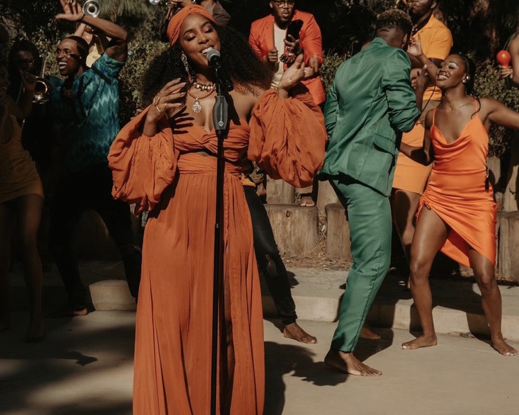 You Ask, We Answer! Kelly Rowland Performed for The Ellen Show Wearing Bronx and Banco Spring/Summer 2021 Rust Off-the-Shoulder Bralette Top, Maxi Skirt and Headband Set