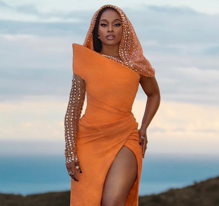 ‘Coming 2 America’ Star Nomzamo Mbatha Dons Tony Ward Couture Orange Crystal-Embellished Hooded Gown and Jimmy Choo Crystal Sandals for Virtual Premier