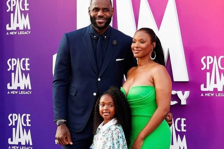 Savannah James Goes Green at the ‘Space Jam: A New Legacy’ Premiere with LeBron and Zhuri James Wearing Alex Perry Green Strapless Midi Dress and Amina Muaddi Green Lace-Up Sandals