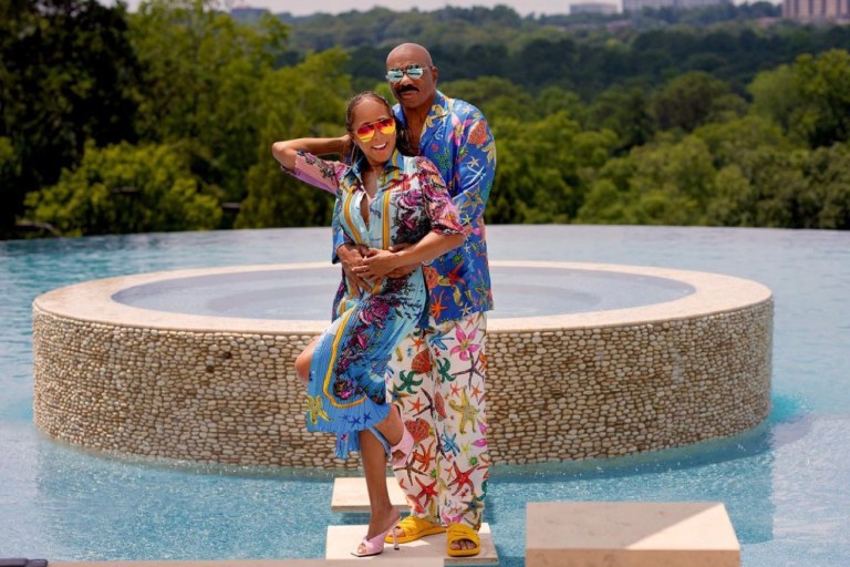 The Harvey’s Celebrate the Fourth of July in Style Wearing Versace Looks With Steve Harvey in a Starfish Print Pajama Shirt and Pants and Marjorie Harvey in a Pleated Dress and Pink Plisse Mules by the Brand