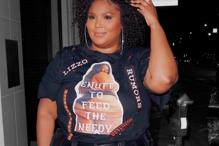 Lizzo Lets Us Know the Rumors Are True in Custom Black Stinson Haus Look Including Graphic T-Shirt and Leather Fringe Pants