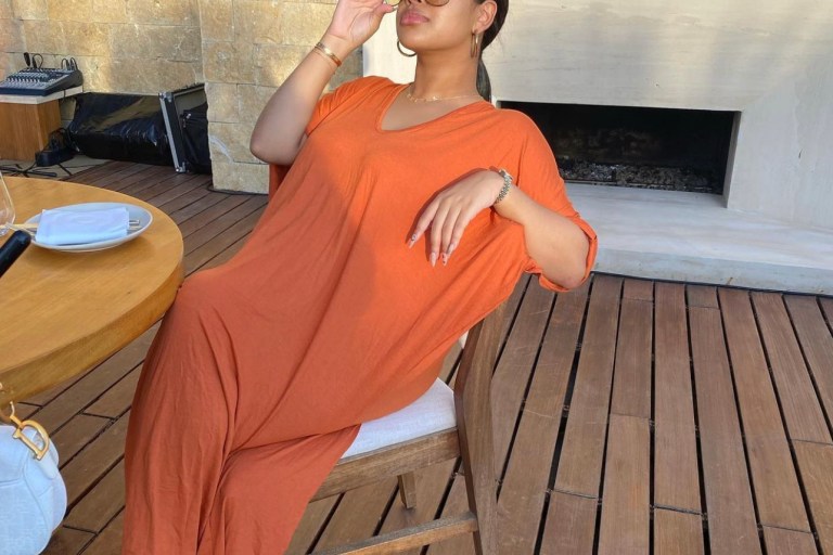 Taina Williams Catches Some Rays Wearing Fashion Nova Orange V-Neck Maxi Dress
