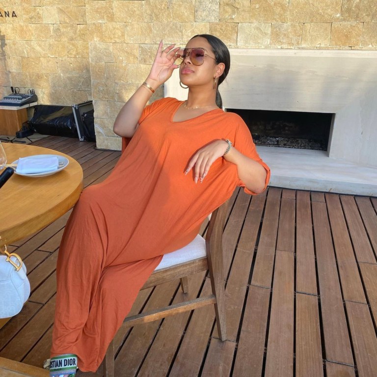 Taina Williams Catches Some Rays Wearing Fashion Nova Orange V-Neck Maxi Dress