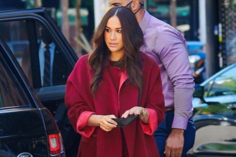 Meghan Markle Visits School and Donates to Local Restaurant in New York City Wearing Loro Piana Red Cashmere Cape and Wide Leg Pants