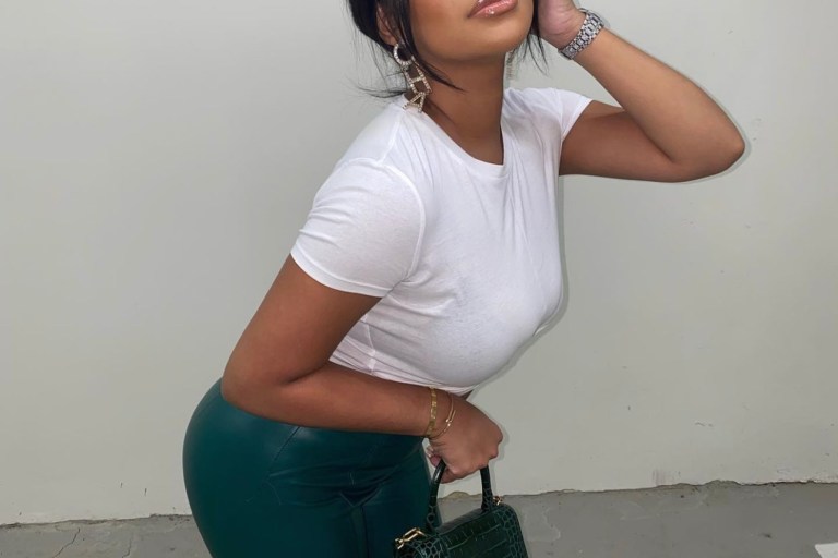 Taina Williams Delivers Casual-Chic Look Wearing White Tee and Fashion Nova Green Faux Leather Pants