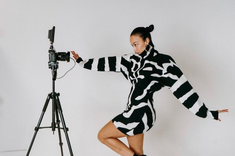 Draya Michele Spotted in Fashion Nova Black and White Turtleneck Mini Sweater Dress