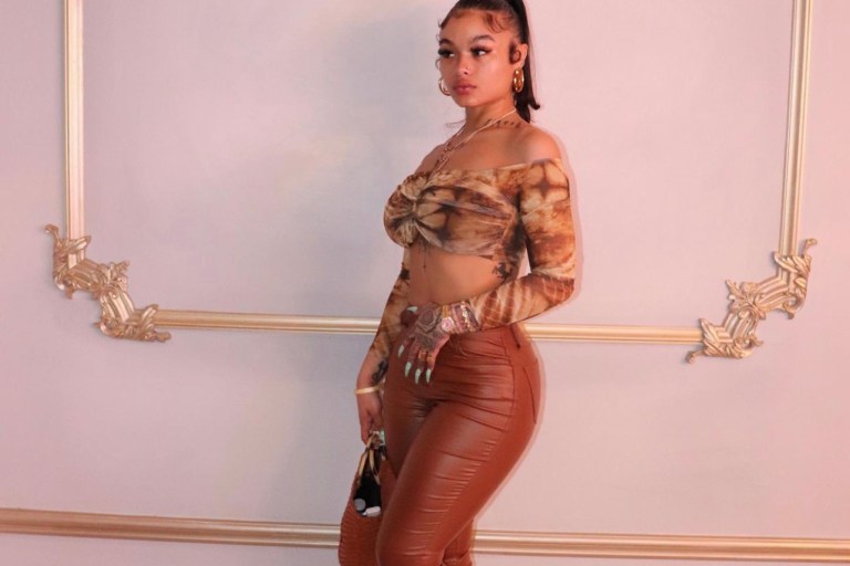 India Love Wears Fashion Nova Tie-Dye Off-the-Shoulder Top and Brown Leather Pants During Outing