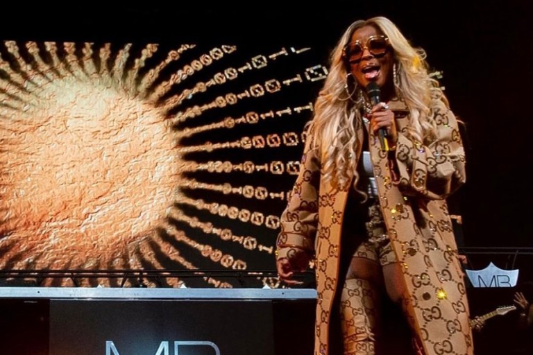 Mary J. Blige Performs at Barclays Center Wearing Gucci Fall 2021 Monogram Crystal Embellished Coat, Shorts, and Balenciaga Collaboration Thigh-High Boots
