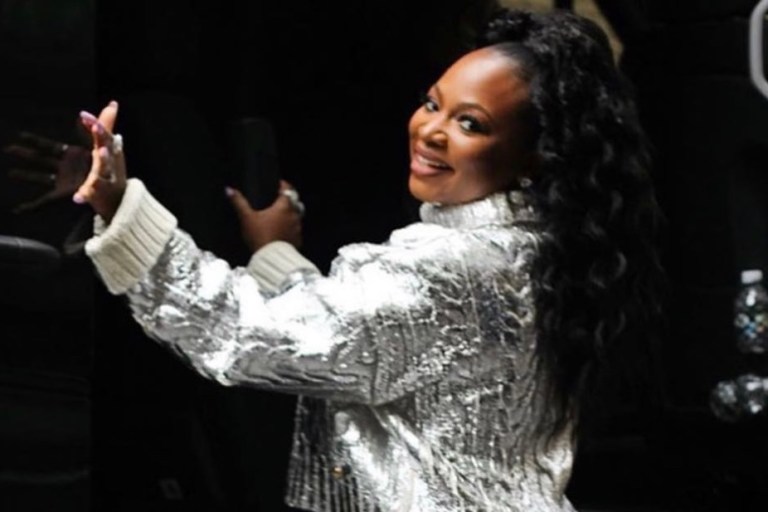 Naturi Naughton Wears Balmain Silver Metallic Turtleneck Sweater and Alice and Olivia White Cable Knit Mini Skirt While Doing Press for ABC’s ‘Queens’