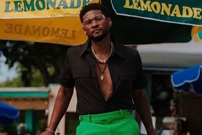 Usher Spotted Roller Skating in Miami Wearing Full Bottega Veneta Look Including Green Wool Suit Jacket, Pants, and Black Short Sleeve Shirt