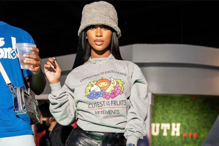 Dess Dior Spotted at Truth Nightclub Wearing Vetements Grey Fruits Graphic Sweatshirt, Marine Serre Black Moon Print Leather Trousers, Grey Fuzzy Bucket and Air Jordan 11 ‘Cool Grey’ Sneakers